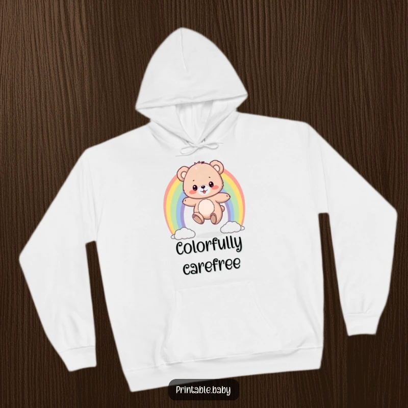 Funny hoodie with a fluffy bear cub bouncing on a colorful rainbow, offering warm, comfortable, and cheerful vibes.