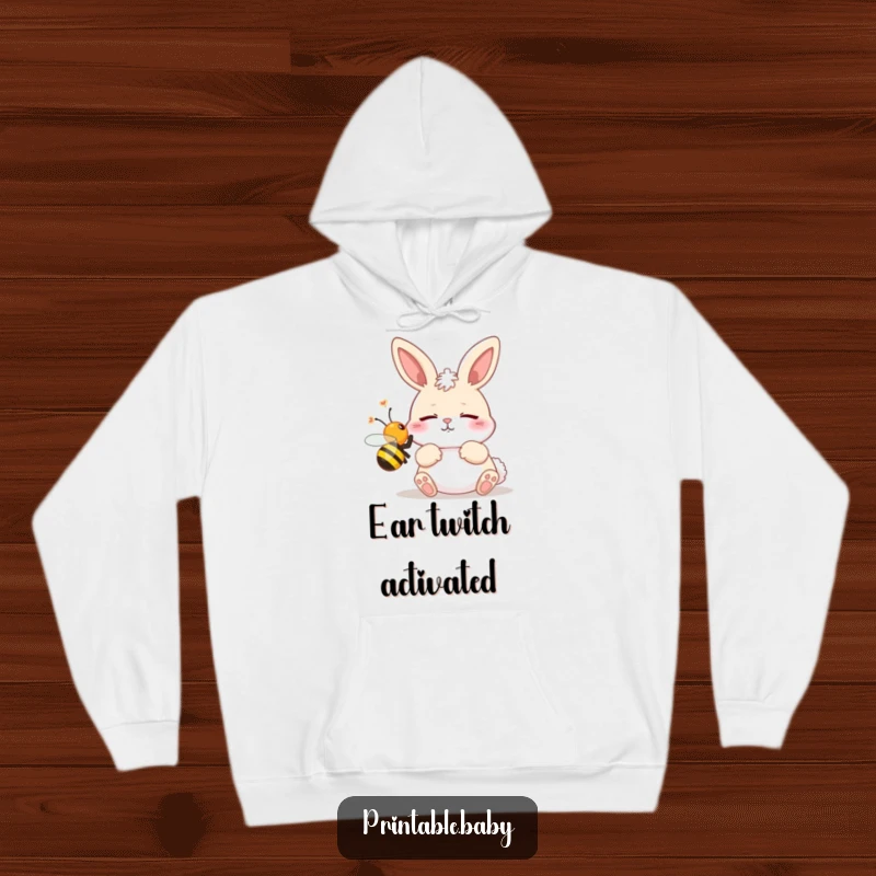Funny hoodie with a plush design of a bunny startled by a buzzing bee, ideal for comfort and humor.