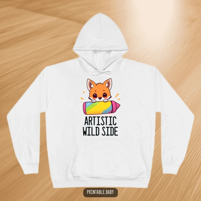 Funny hoodie showcasing a surprised fox cub peeking over a giant colorful crayon, perfect for cozy creative sessions.