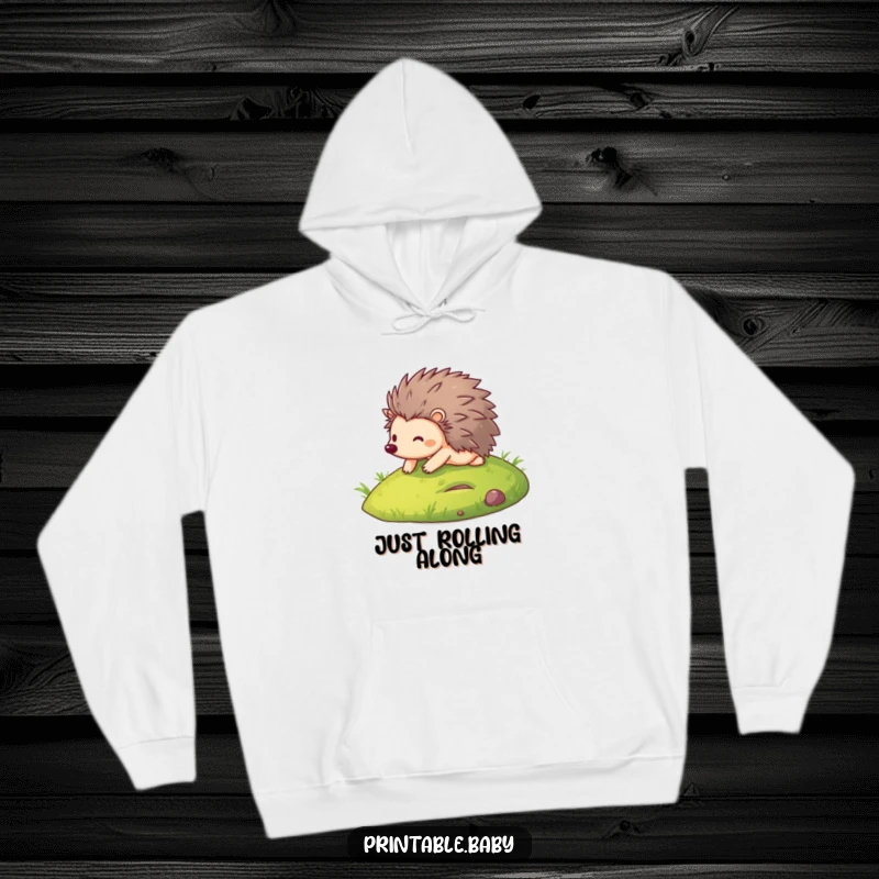 Funny hoodie illustrating a happy hedgehog gleefully rolling down a grassy slope, radiating pure joy and playful energy.