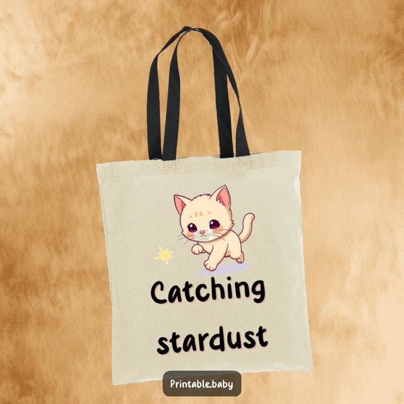Funny tote bag with a curious kitten chasing a sparkly comet tail, bringing interstellar charm.